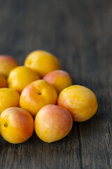 Close-up of small red apricots on wooden board, origin in Xinjiang, China