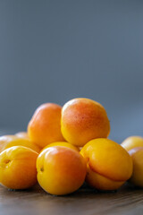 Close-up of small red apricots on wooden board, origin in Xinjiang, China