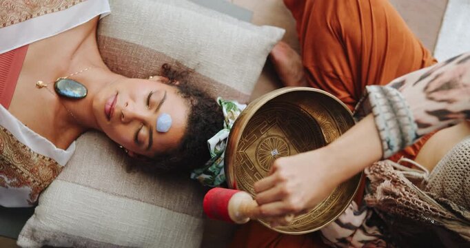 Singing bowl, meditation and woman on floor with healer for sound therapy, vibration or chakra balance from above. Healing, crystal or female person with shaman for energy, cleaning or holistic care