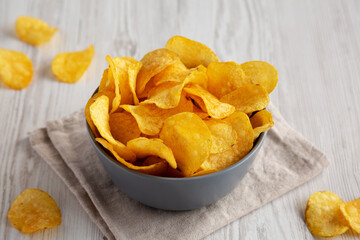 Bacon Flavored Potato Chips in a Bowl, side view. Close-up.