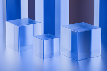 Transparent blue cubes of varying sizes displayed on a reflective surface. 3d rendering