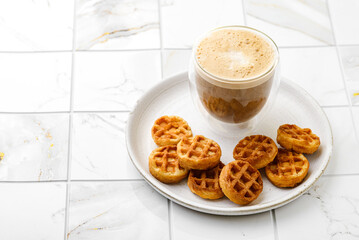 cappuccino and waffles on a plate