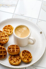 cappuccino and waffles on a plate