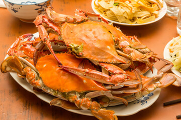 Cooked crab with chinese noodles on a wooden table