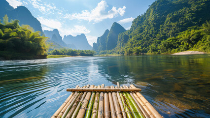 A serene bamboo raft floats on a tranquil river, surrounded by lush mountains and a clear blue sky, perfect for nature exploration.