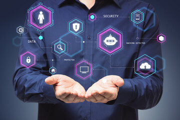 Businessman holding holographic icons representing data security and networking concepts.