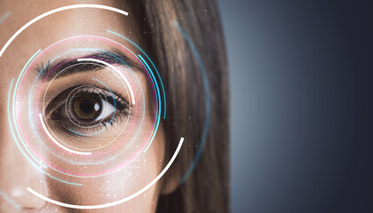 Close-up of a human eye with holographic interface overlays on a futuristic background.