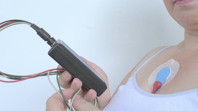sensors on female body for Holter monitoring, woman with Holter monitor for daily monitoring of electrocardiogram, blood pressure, cardiac examination, treatment of cardiac diseases