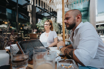 Startup team having a business meeting outdoors at a cafe, discussing strategy and brainstorming...