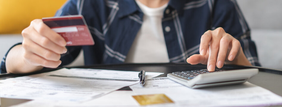 Business financial concept, stressed asian young woman hand checking list statement of credit card  for calculate accounting expense, tax for payment on due deadline, trying to find money to pay debt