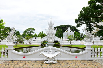 Chaing Rai, Thailand - July 27 ,2024 : White Temple (Wat Rong Khun) is one of the most famous attractions of Chiang Rai Province Northern Thailand. This was on a cloudy afternoon during wet season. 