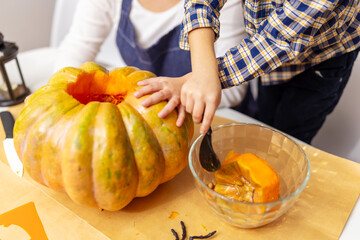Child carving pumpkin for Halloween