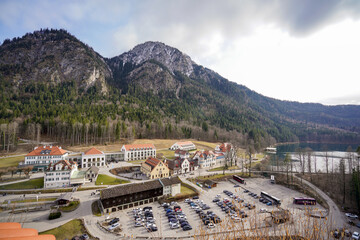 Fototapeta premium Holiday homes and car park against the backdrop of the Alps.