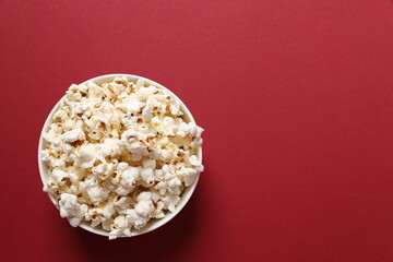Delicious popcorn on a colored background