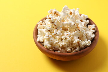Delicious popcorn on a colored background
