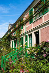 Facade of house museum of the French Impressionist painter Claude Monet, in picturesque town of Giverny, region of Normandy, France.