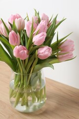 Beautiful fresh tulips on color background