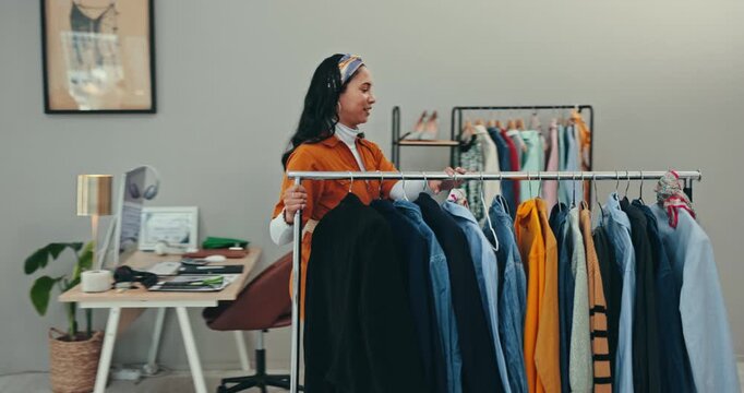 Designer woman, fashion and rail in workshop, walk or moving product in factory, manufacturing or thinking. Tailor, small business owner or clothes collection for vision, boutique or fabric in studio