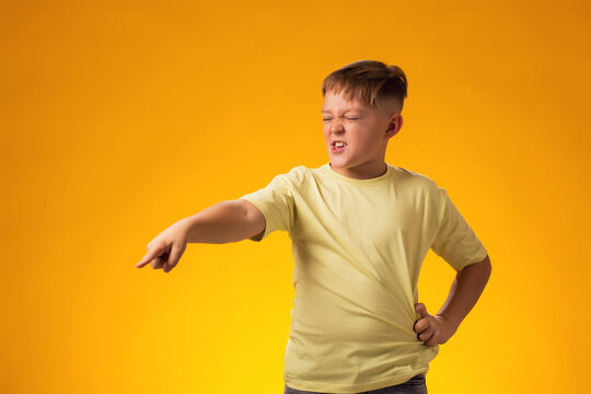 Kid boy laughing at somebody and pointing finger. Bulling concept