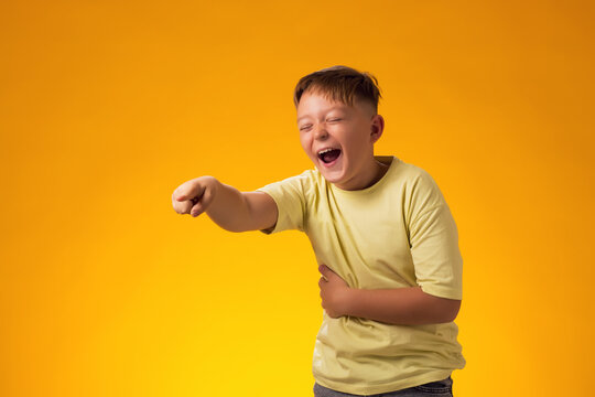Kid boy laughing at somebody and pointing finger. Bulling concept