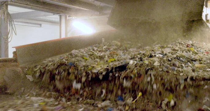  Footage of Refuse-Derived Fuel (RDF) on Conveyor Belt in Recycling Facility - Sustainable Waste Management and renewable energy production.