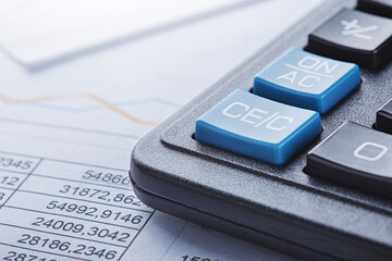 calculator and financial charts. Investment and capital accumulation concept