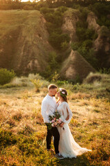 Cute and beautiful just married couple embracing, love is in the air.