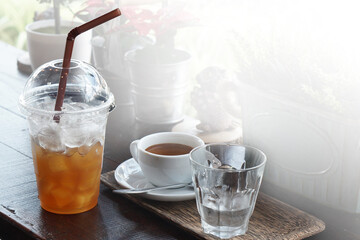 Cold black coffee drinks placed on a wooden table