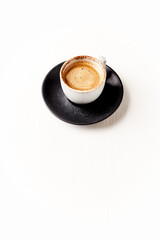 Cup of coffee on bright wooden background. Copy space.
