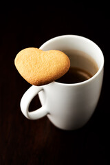 Chocolate cookie and Coffee in glass cup on rustic wooden background. Close up.	