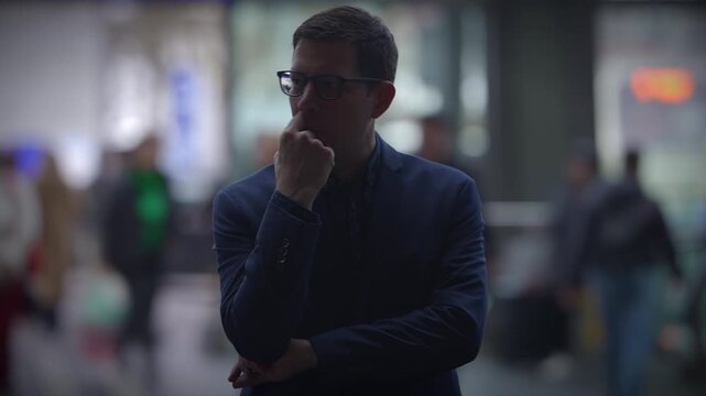 In the midst of a bustling city, a man is lost in deep contemplation, his thoughts consuming him