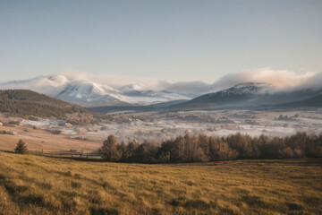 Fototapeta premium Misty morning shrouds the autumnal mountain peaks, casting an ethereal glow on the vibrant landscape