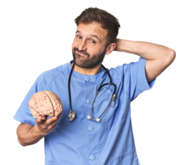 Hispanic male nurse holding brain touching back of head, thinking and making a choice.
