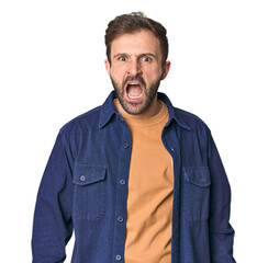 Studio portrait of young Hispanic male shouting very angry, rage concept, frustrated.