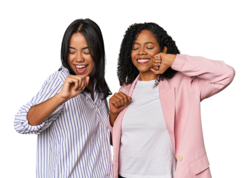 Young Latin businesswomen in studio celebrating a special day, jumps and raise arms with energy.