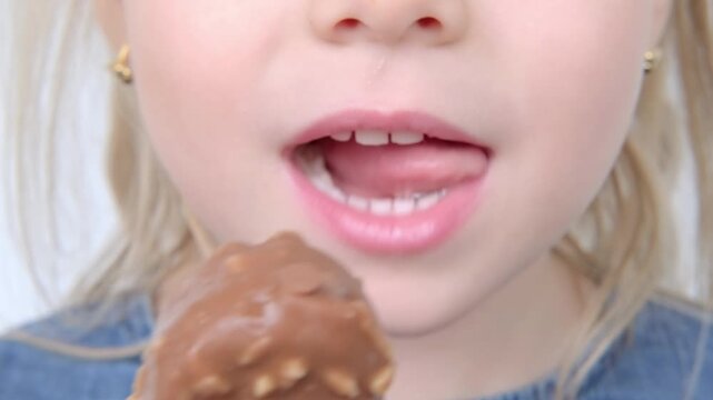 happy little girl enjoys delicious chocolate Eskimo ice cream, child eating sugary snack, Summertime sweetness, Childhood memories, Simple joys, sweet treat on hot day