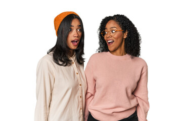 Young Latin friends together in studio being shocked because of something she has seen.