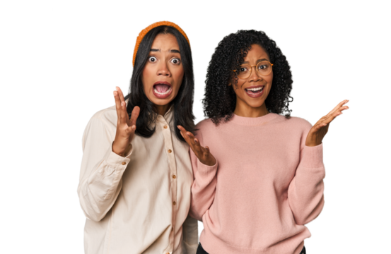 Young Latin friends together in studio screaming to the sky, looking up, frustrated.