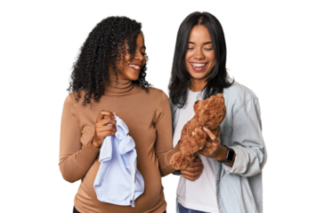 Two Latin women, one pregnant, with teddy bear in studio