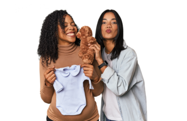 Two Latin women, one pregnant, with teddy bear in studio