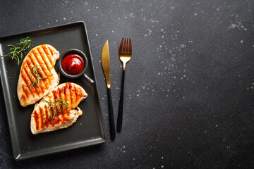 Chicken steak BBQ grill on black background. Flat lay with copy space.