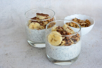 a glass of chia pudding with bananas and walnut 