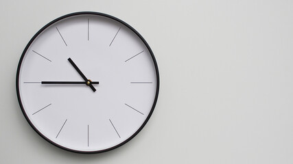 Wall Clock Showing 22.45/10.45 O'Clock on White Wooden Surface - Perfect for Time Management and Scheduling Concepts