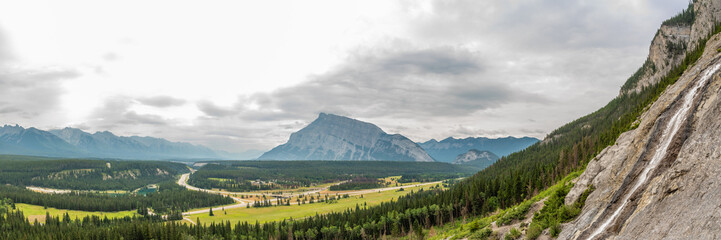 Fototapeta premium Stunning views over Banff from Cascade Falls in the Canadian Rockies during summer time with forest fire, smoke haze in scenic landscape area.