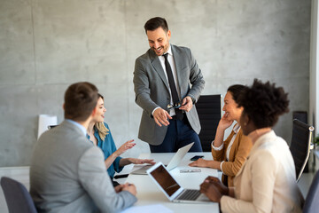 Fototapeta premium Multicultural professional businesspeople working together on research plan in boardroom.