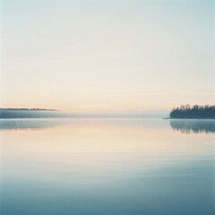 Fototapeta premium A serene and tranquil lake at dawn, reflecting soft pastel colors and surrounded by nature's calm beauty.