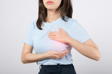 Breast cancer checking. Woman checking her breast on white background. How do I check breast...