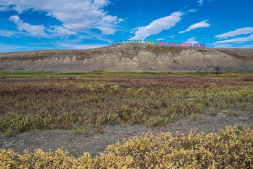 "Holy Spirit You Are Welcome Here", hillside signage somewhere on the Siksika Nation along Highway 547, north of the the Bow River and well to the south of Gleichen, Alberta, Canada.