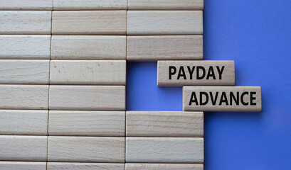 Payday Advance symbol. Concept word Payday Advance on wooden blocks. Beautiful purple background. Business and Payday Advance concept. Copy space