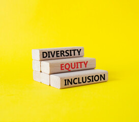 Diversity Equity Inclusion symbol. Concept words Diversity Equity Inclusion on wooden blocks. Beautiful yellow background. Business and Diversity Equity Inclusion concept. Copy space